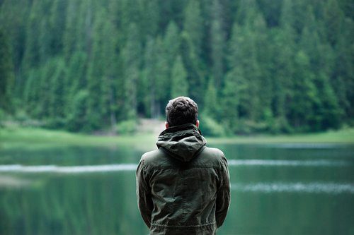 Man looking out over lake after losing relationship - rebuilding session